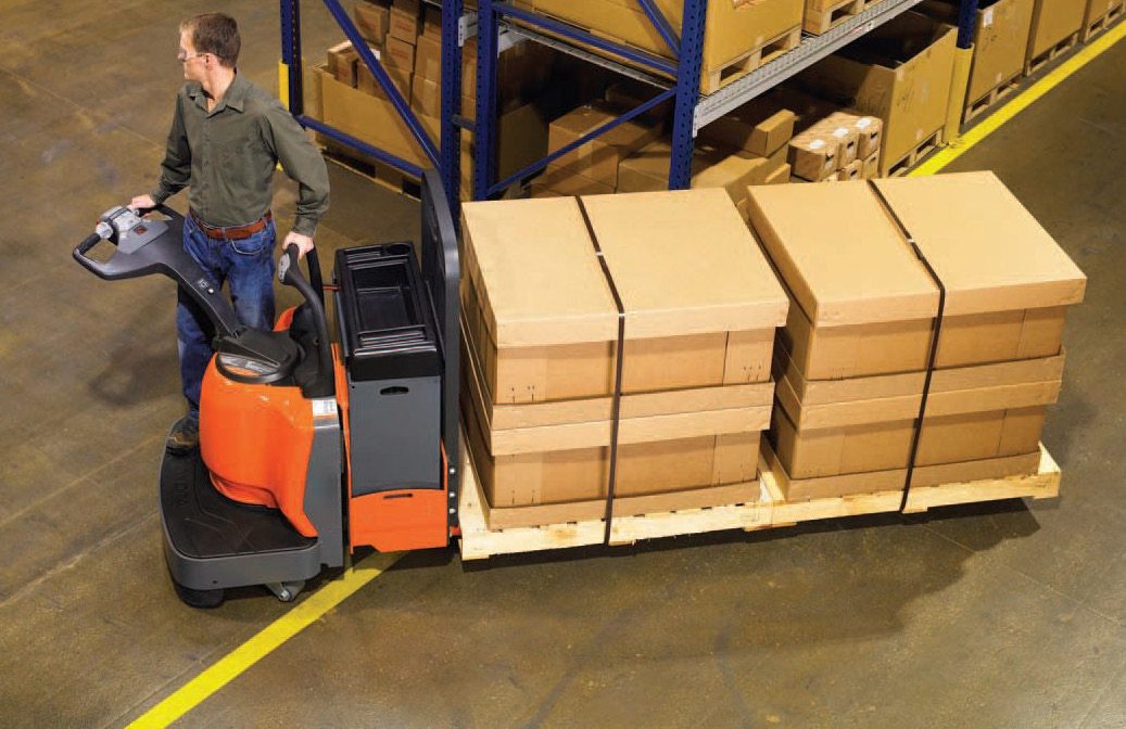 Battery operated pallet truck moving palletised boxes