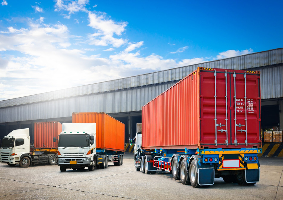 Fleet of container trucks at Omkar Enterprise loading dock