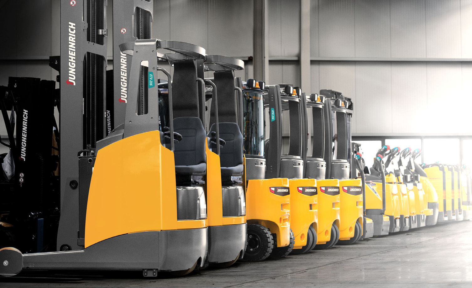 Row of reach trucks in a warehouse aisle